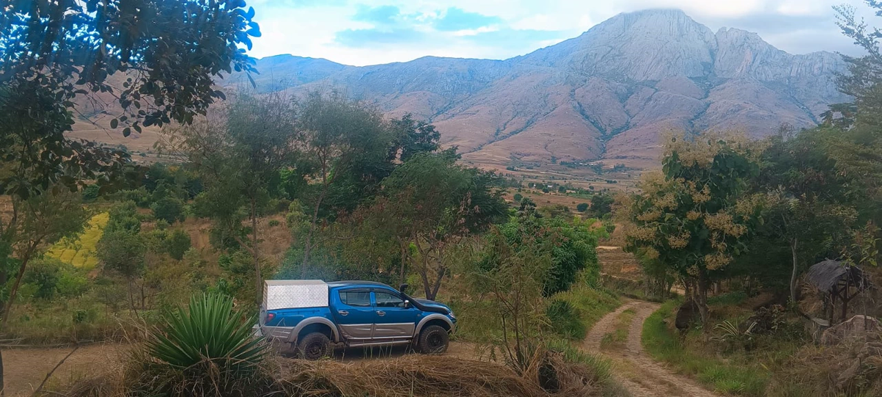Mitsubishi L200 pickup against a mountain backdrop in the highlands of Madagascar