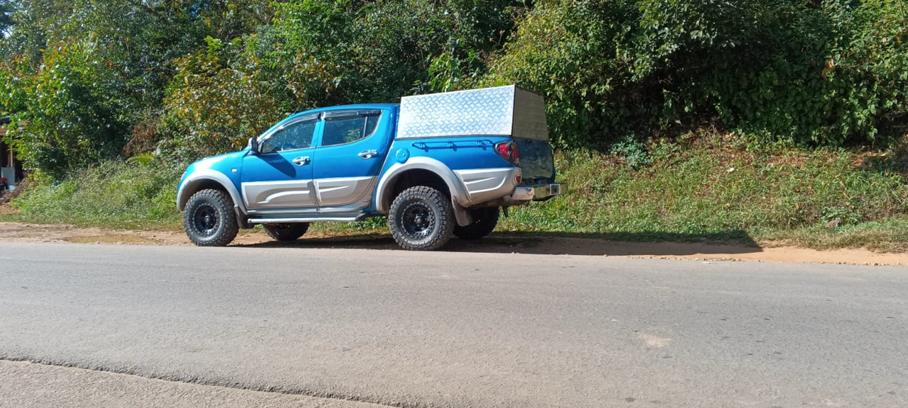 Mitsubishi L200 pickup side view on a road in Madagascar