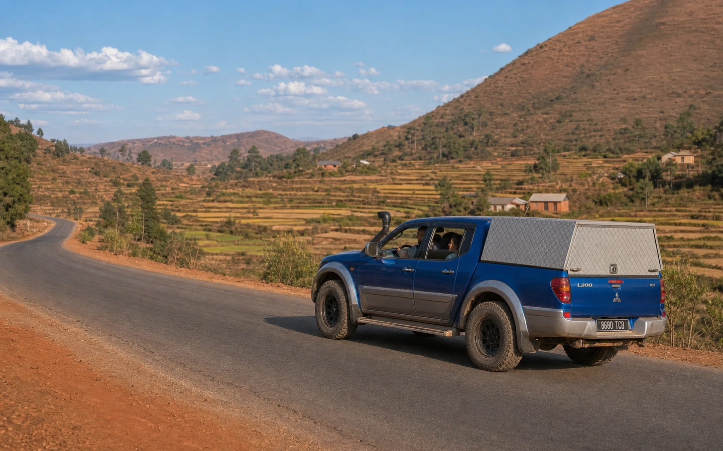 Blue Mitsubishi L200 travelling along the RN7 in Madagascar’s highlands