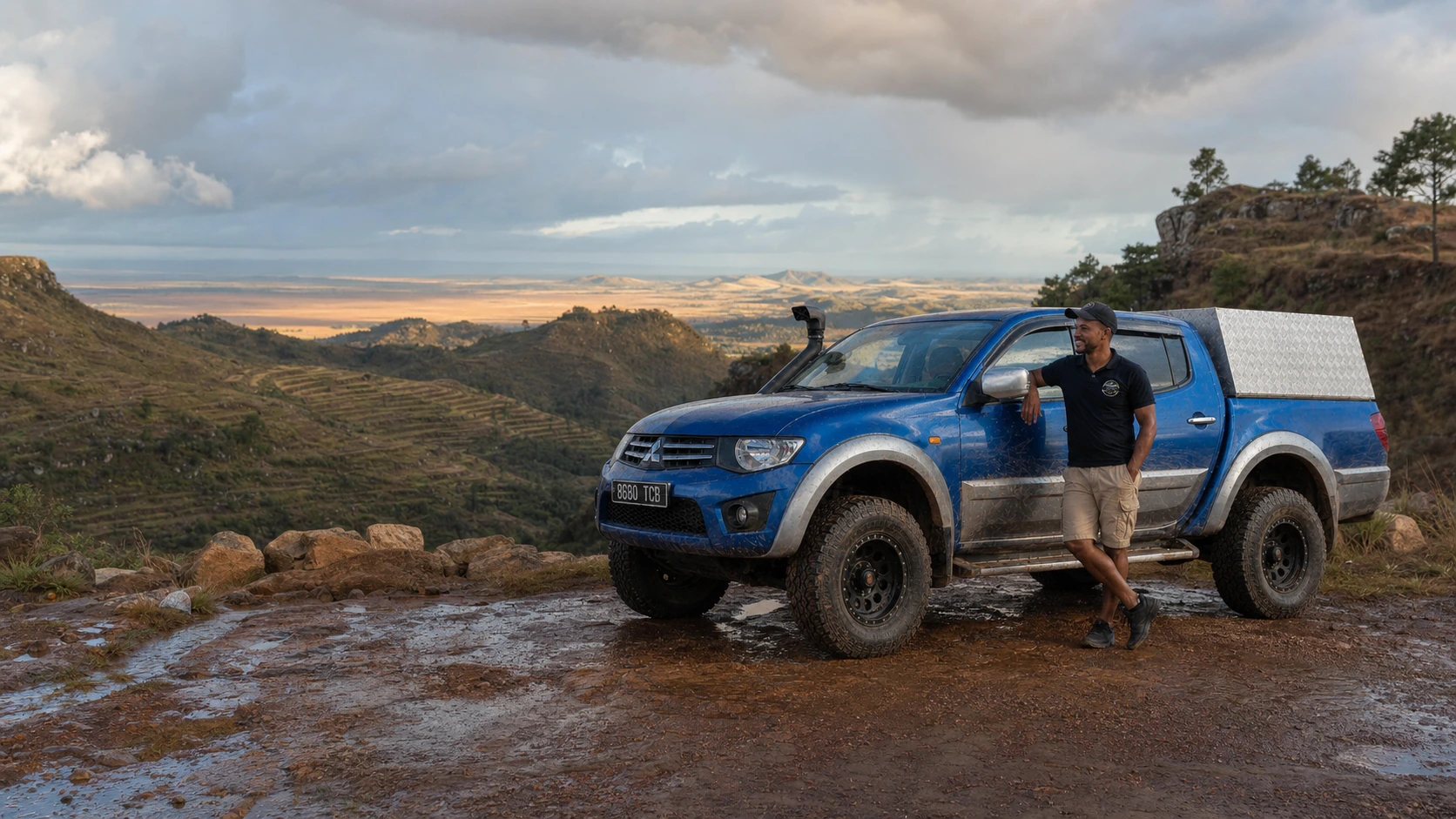 Driver-guide with travellers at a green viewpoint in Madagascar’s highlands